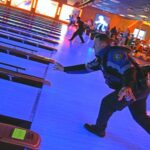 Officer Joshua Delisle bowls at Bowlero in Lowell as part of a program that partnered Lowell Police Offiers with city youth.