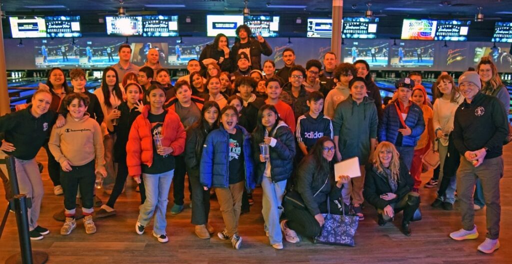 Police officers, Lowell Housing Authority residents and youth who participated in the program stand together for a group photo.